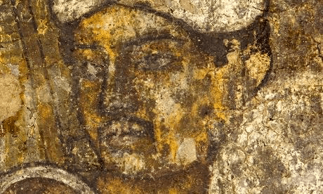 Weathered Ajanta fresco showing the face of a painted figure