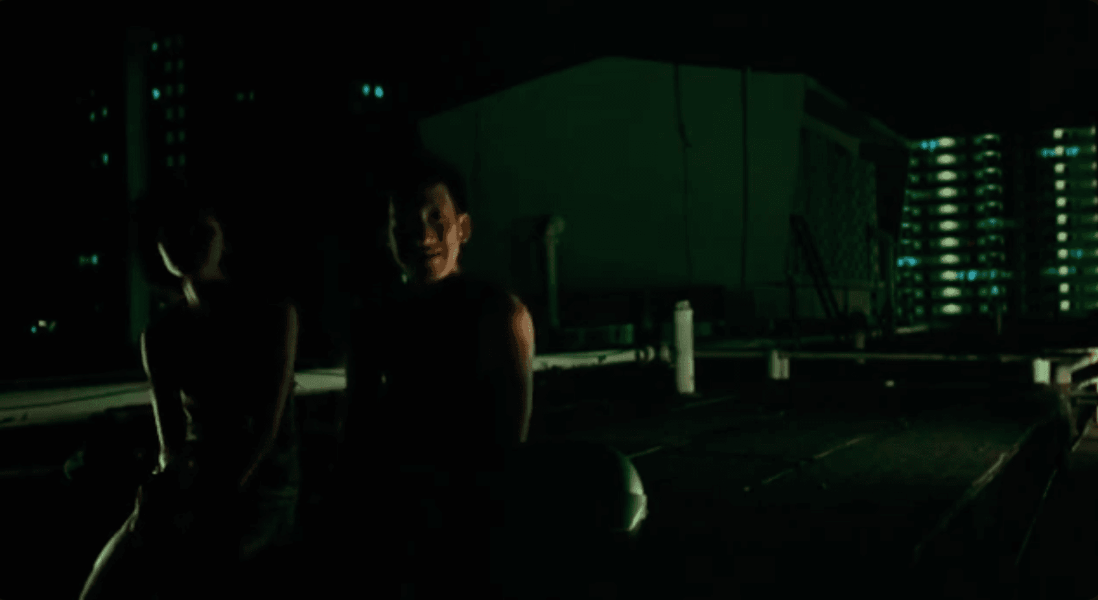 Night scene from Eating Air with two figures in shadow