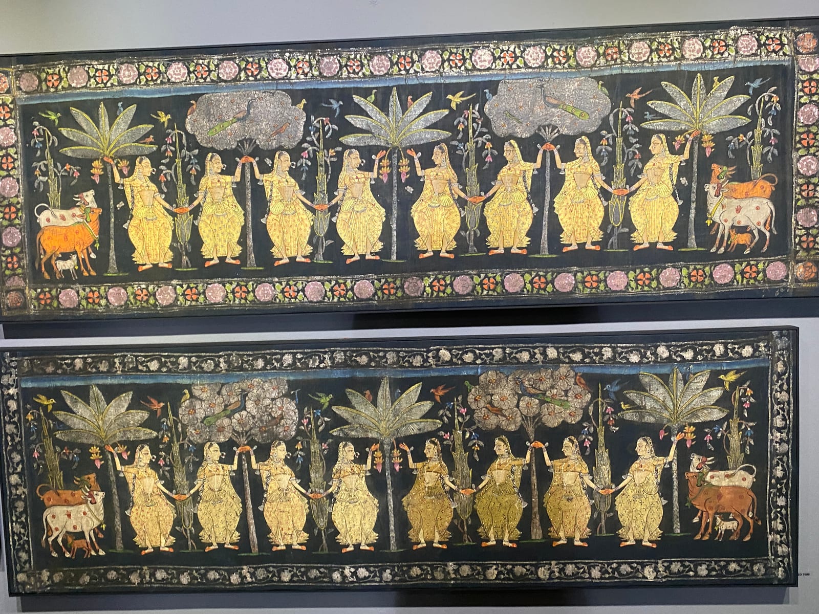 Dark Pichvai panel with gilded figures, cows and banana trees