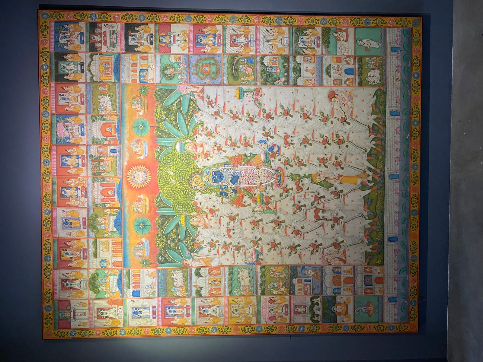 A Pichvai textile arranged as a grid of small devotional paintings